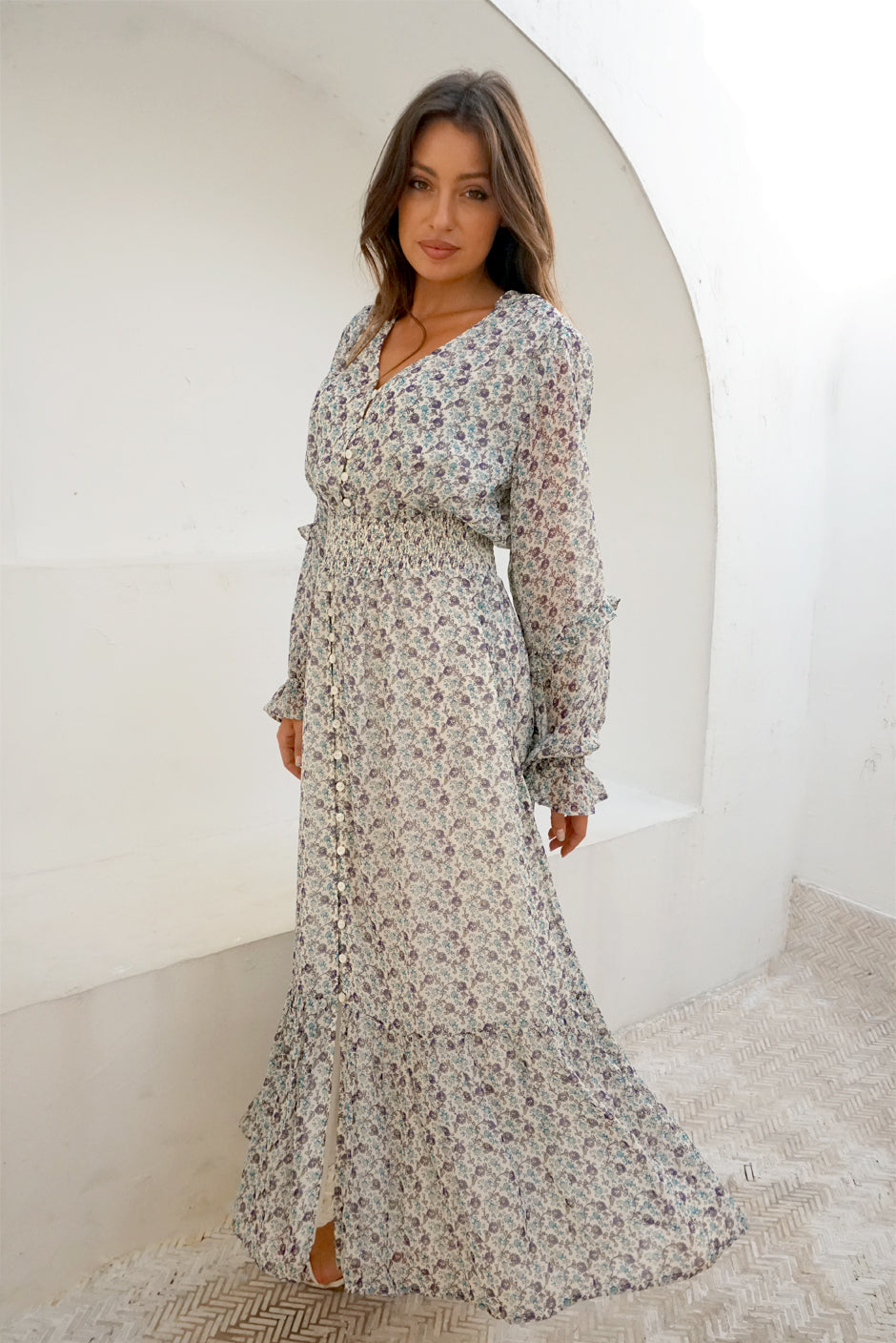 White/Blue/Purple Floral Print Long Sleeve Women's Aria Ankle-lenght Maxi Dress from Paneros Clothing with 100% certified sustainable fabric, ruffles, button-up front, and smocking. Front View.
