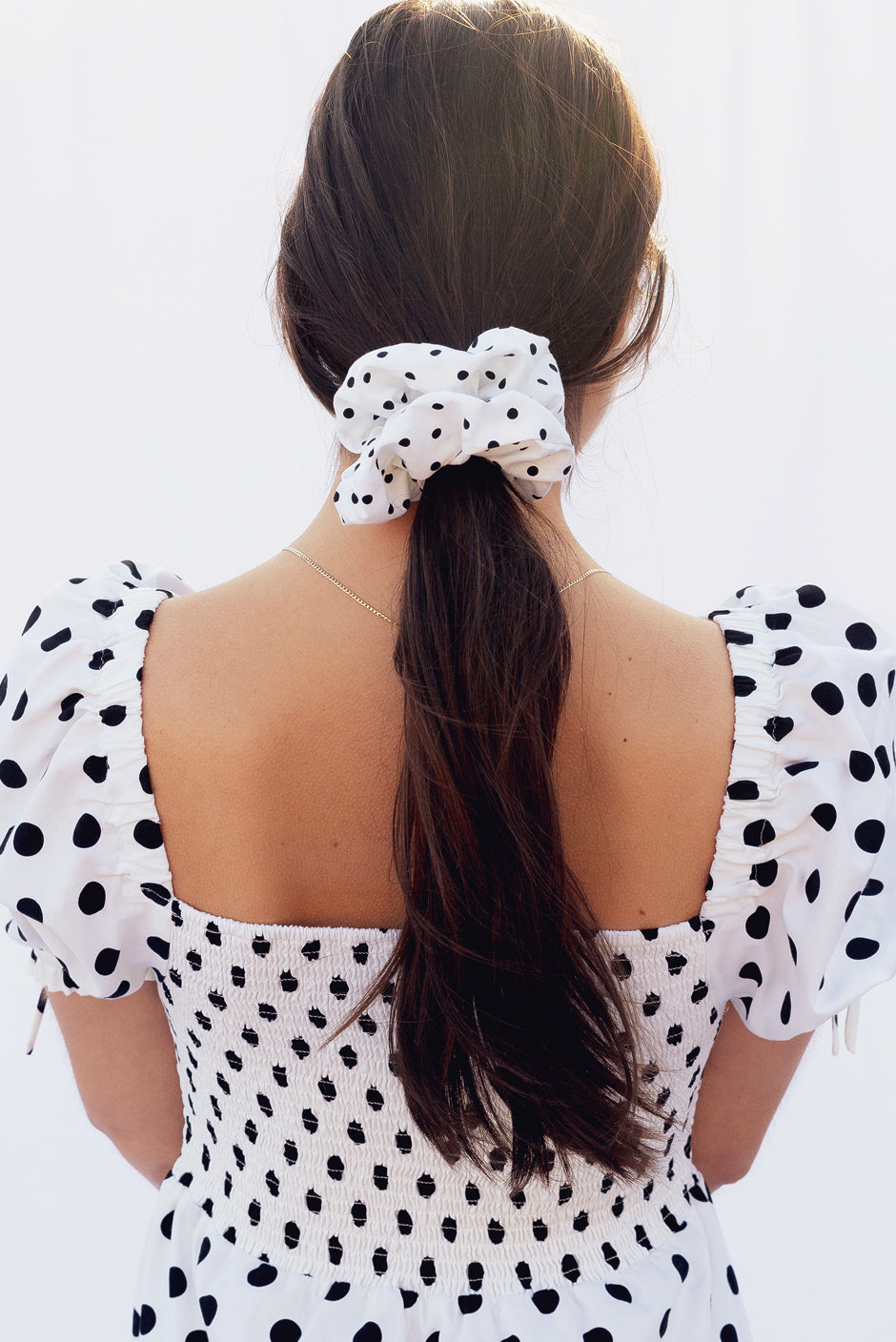Babe scrunchie in polka dot print for women by Paneros Clothing. Hair Tied view.