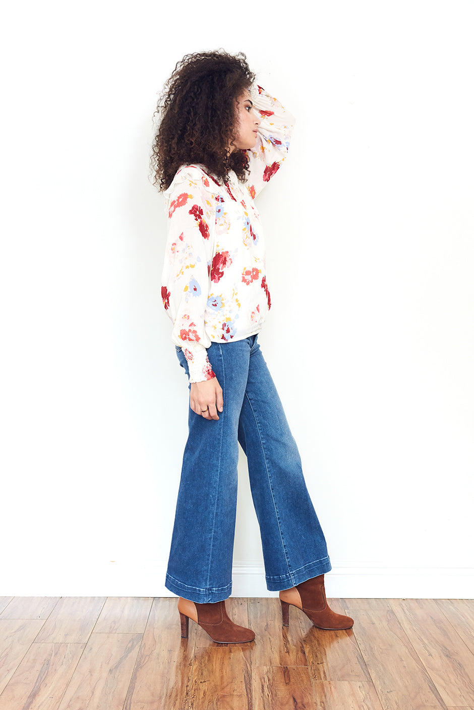 Mabel Blouse in Prairie Bloom print for women by Paneros Clothing. Made from 100% deadstock rayon fabric. Side view walking.