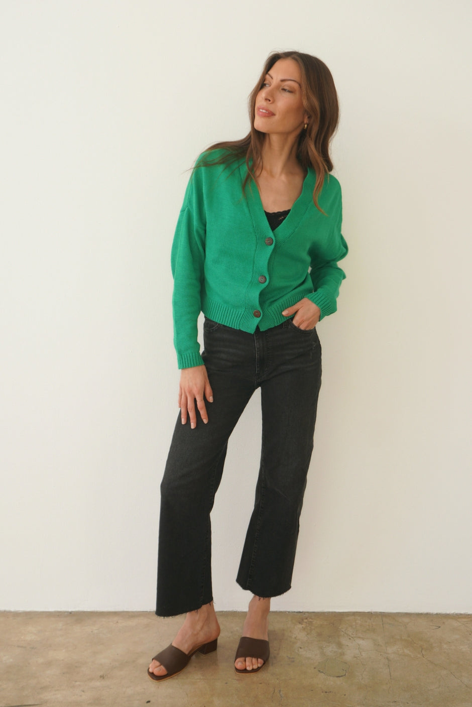 Emerald Green sustainable cropped-length Cotton Diana Cardigan from Paneros Clothing with real coconut shell button-up front, Full sleeves, and feminine handknittting. Front View buttoned.