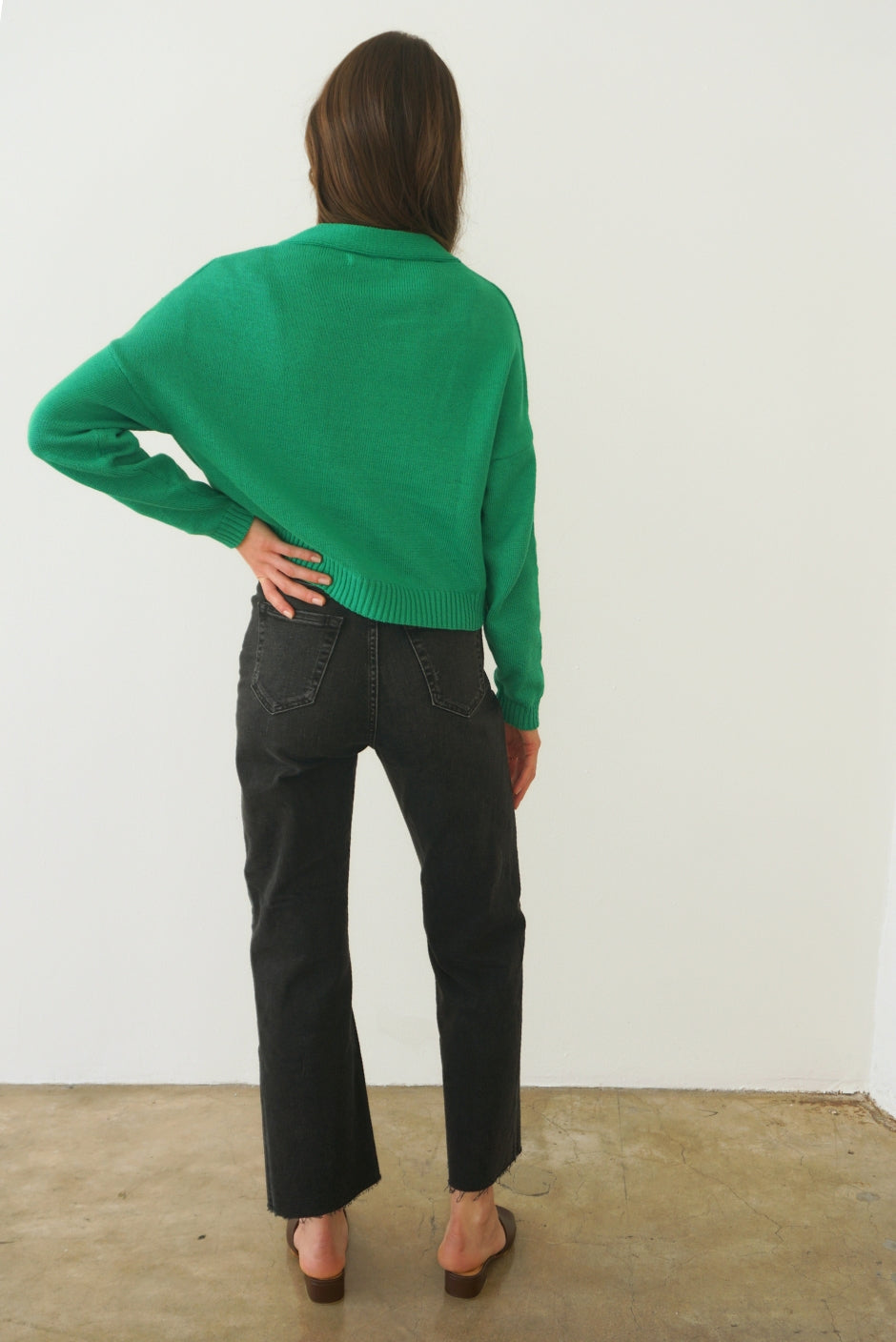 Emerald Green sustainable cropped-length Cotton Diana Cardigan from Paneros Clothing with real coconut shell button-up front, Full sleeves, and feminine handknittting. Back View.