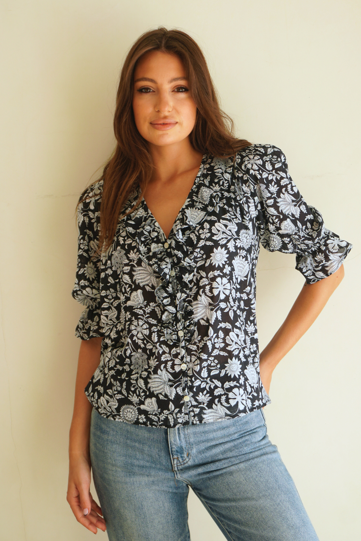 Black Floral Spring/Summer Chloe Shirt from Paneros Clothing with button-up front and Elbow-length sleeves and ruffles. Sustainable cotton fully-lined top with smocking. Front View untucked.