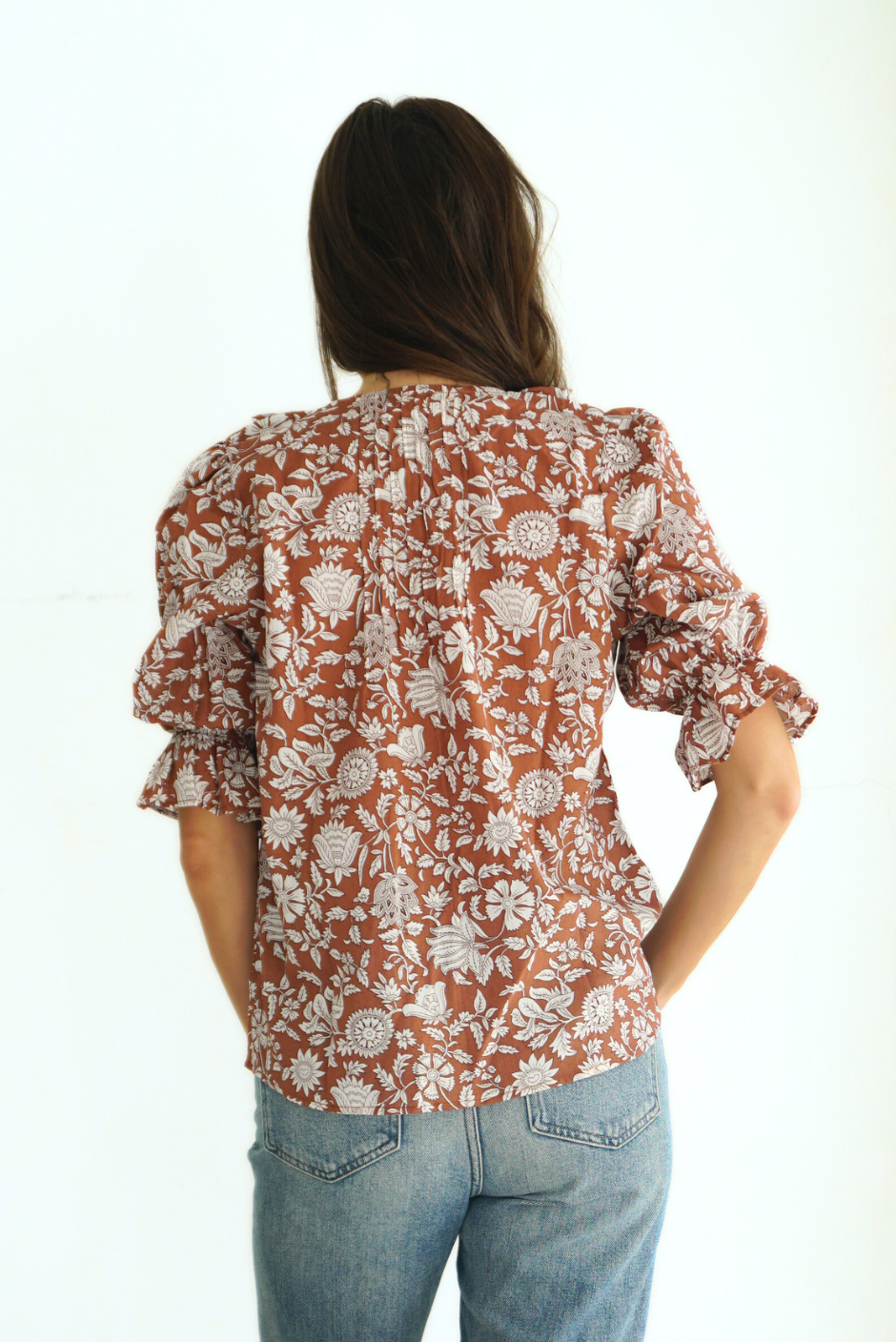 Brown Floral Spring/Summer Chloe Shirt from Paneros Clothing with button-up front and Elbow-length sleeves and ruffles. Sustainable cotton fully-lined top with smocking. Back View.