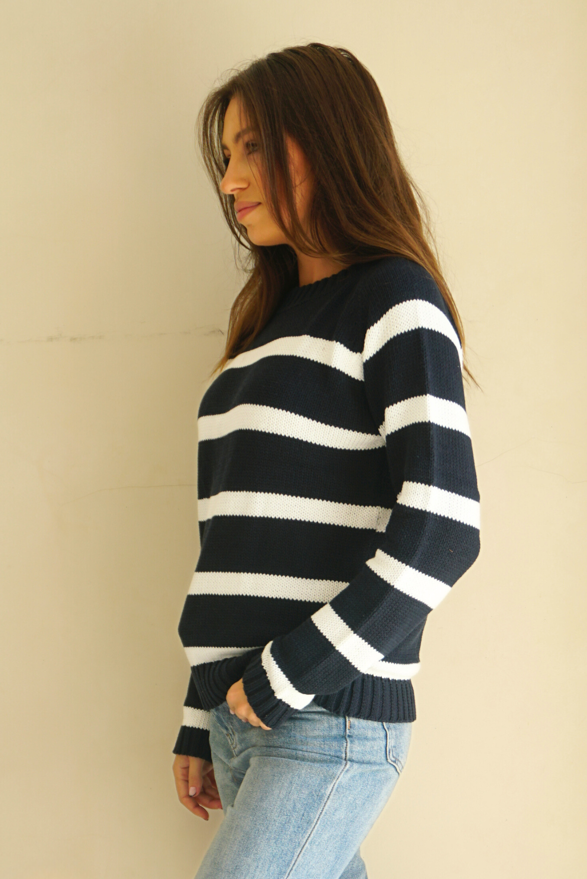 White and Navy Blue Striped sustainable cotton handknitted Sloane Crewneck by Paneros Clothing. Relaxed-fit hip-length crewneck sweater with long sleeves and ribbing details. Side View.