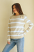 Soft Tan and Creamy Off-White Striped sustainable cotton handknitted Sloane Crewneck by Paneros Clothing. Relaxed-fit hip-length crewneck sweater with long sleeves and ribbing details. Front/Side View.