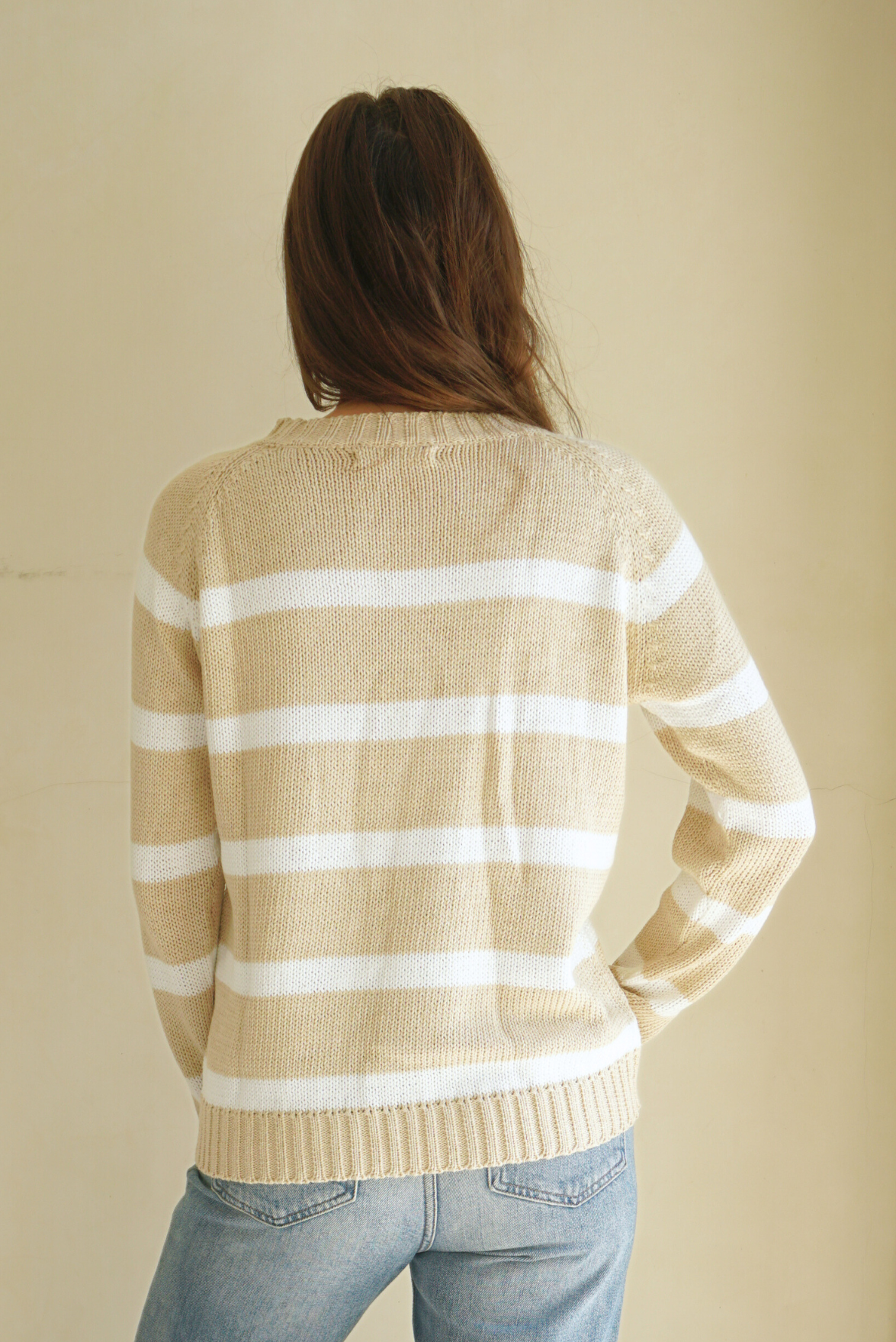 Soft Tan and Creamy Off-White Striped sustainable cotton handknitted Sloane Crewneck by Paneros Clothing. Relaxed-fit hip-length crewneck sweater with long sleeves and ribbing details. Back View.