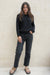 Black sustainable cotton handknitted Sloane Crewneck by Paneros Clothing. Relaxed-fit hip-length crewneck sweater with long sleeves and ribbing details. Front View untucked.