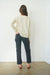 Creamy Off-White sustainable cotton handknitted Sloane Crewneck by Paneros Clothing. Relaxed-fit hip-length crewneck sweater with long sleeves and ribbing details. Back View.