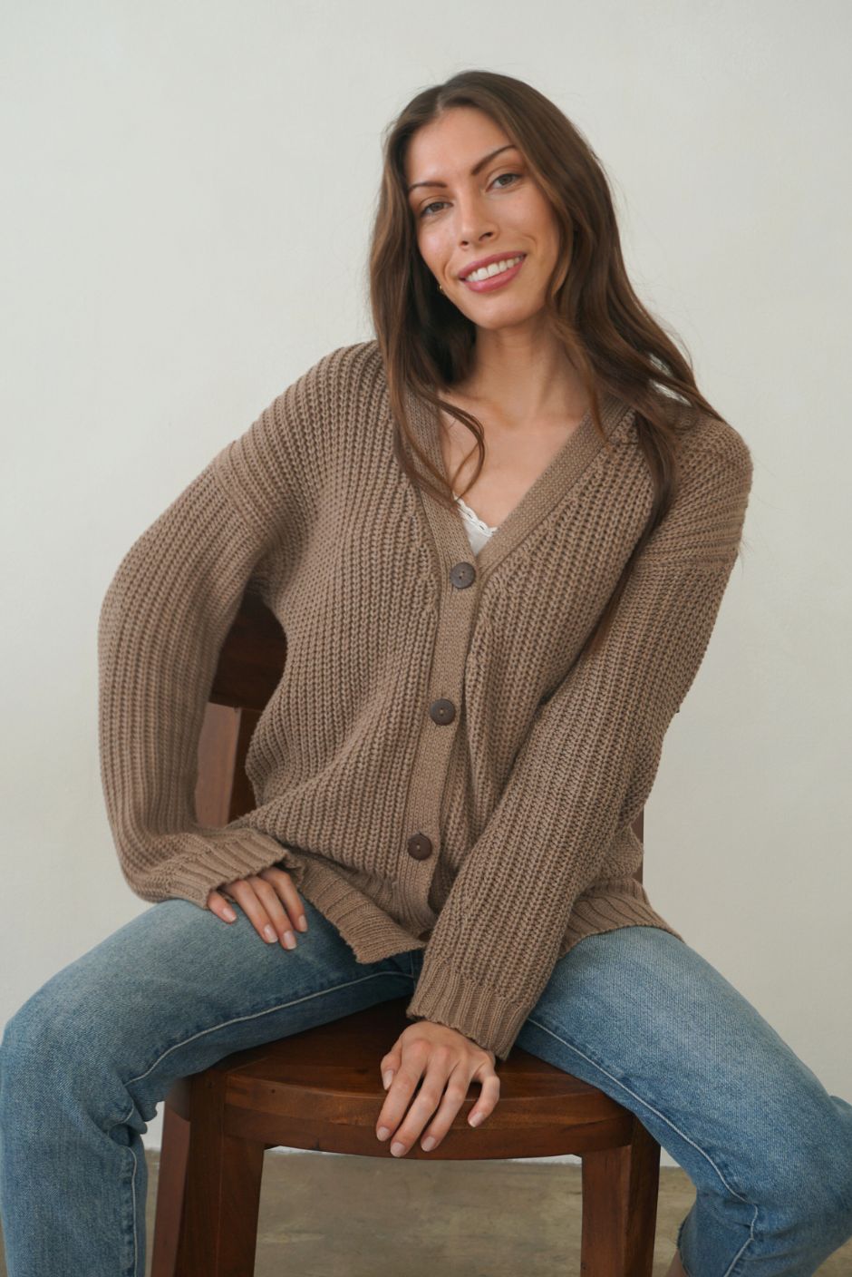 Mocha Brown Sustainable Cotton Hip-Length Button-up Emily Cardigan by Paneros Clothing. Hand-knitted, slightly oversized cardigan with real coconut shell buttons and ribbed detailing. Front View buttoned.