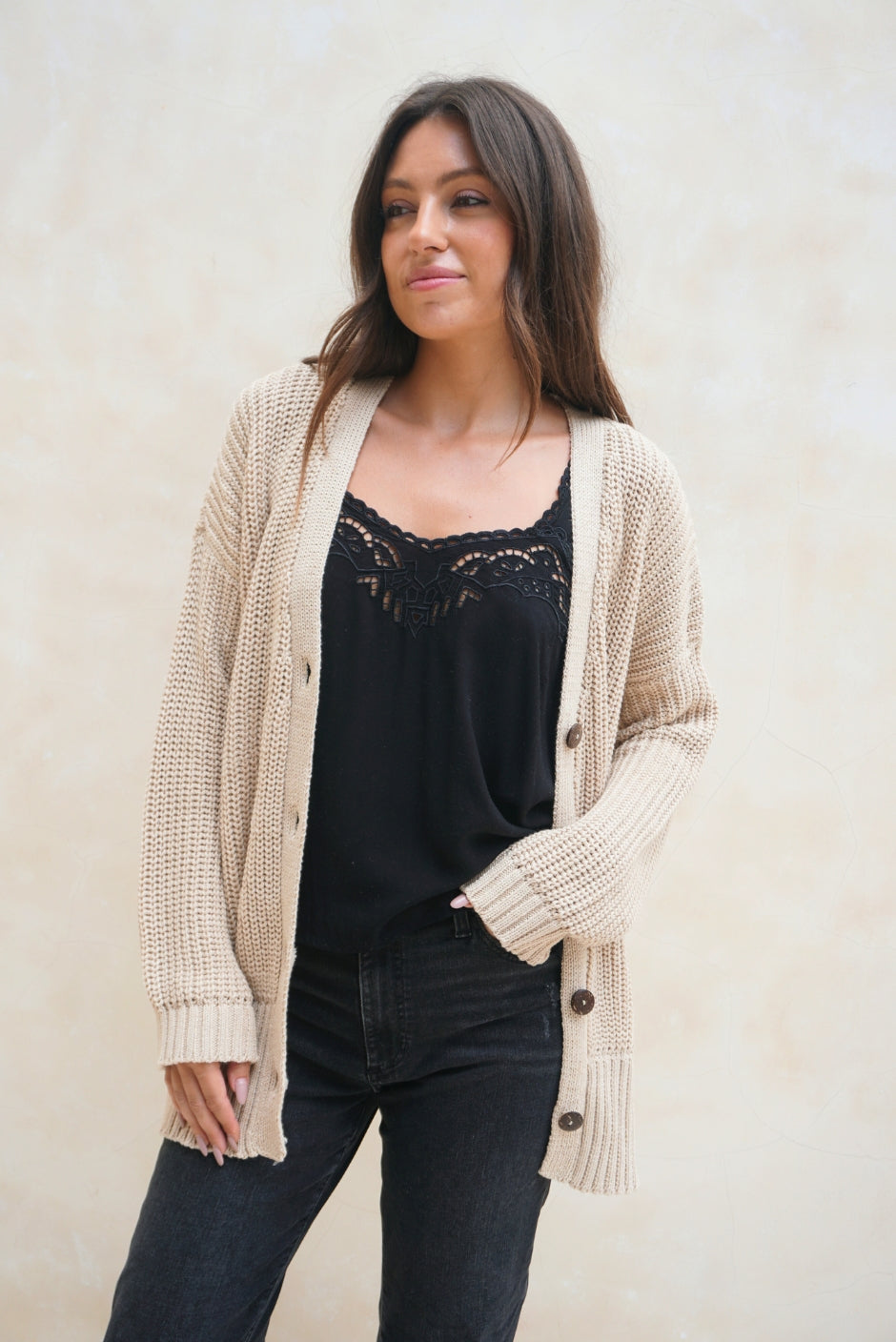 Tan Sustainable Cotton Hip-Length Button-up Emily Cardigan by Paneros Clothing. Hand-knitted, slightly oversized cardigan with real coconut shell buttons and ribbed detailing. Front View unbuttoned.