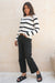 Black and White Striped sustainable cotton handknitted Sloane Crewneck by Paneros Clothing. Relaxed-fit hip-length crewneck sweater with long sleeves and ribbing details. Front/Side View tucked into denim.