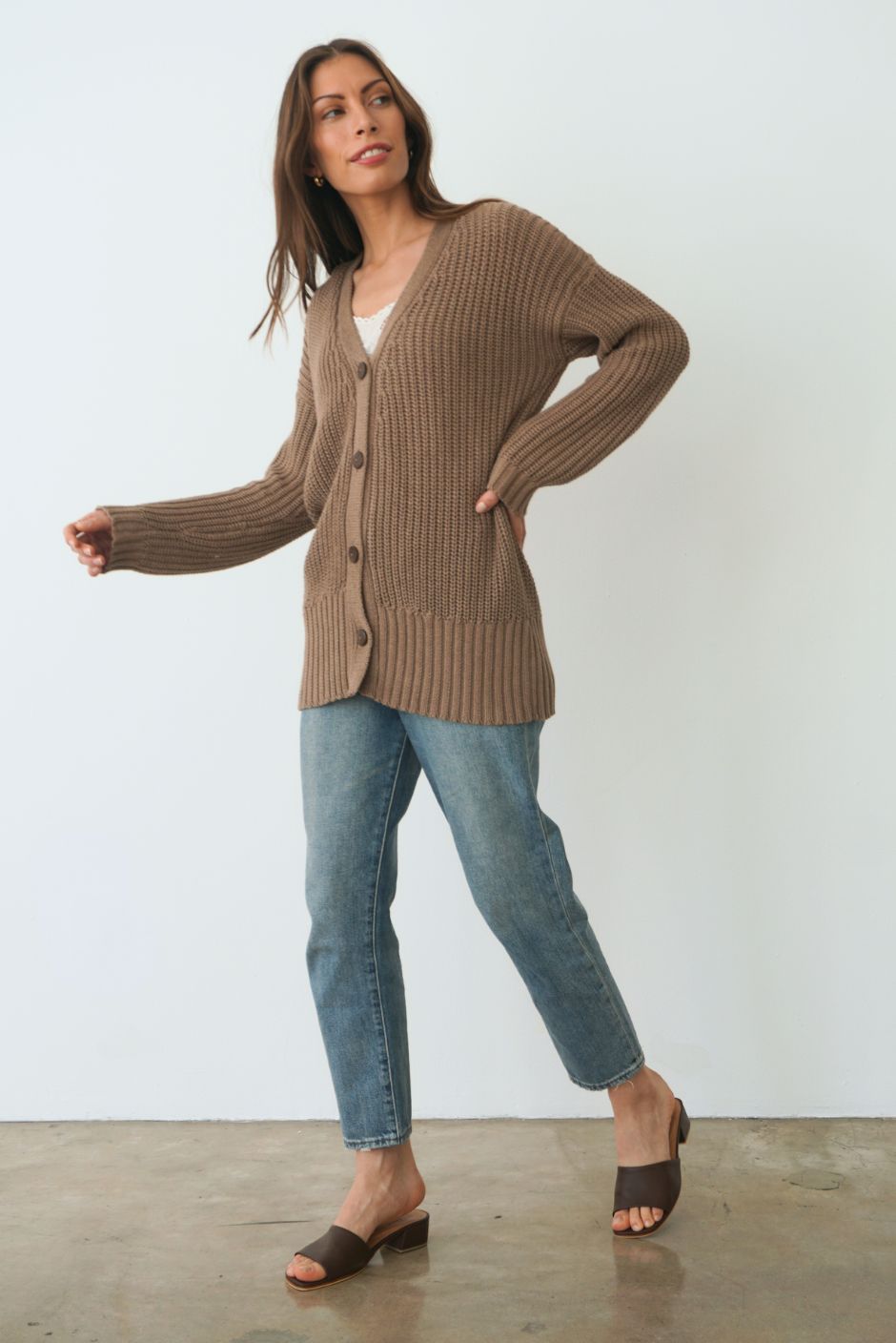 Mocha Brown Sustainable Cotton Hip-Length Button-up Emily Cardigan by Paneros Clothing. Hand-knitted, slightly oversized cardigan with real coconut shell buttons and ribbed detailing. Side View buttoned.