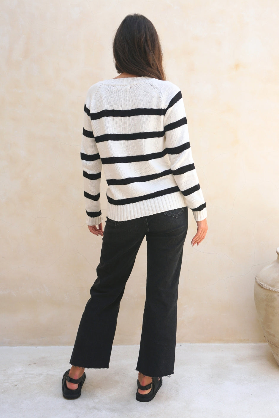 Black and White Striped sustainable cotton handknitted Sloane Crewneck by Paneros Clothing. Relaxed-fit hip-length crewneck sweater with long sleeves and ribbing details. Back View.