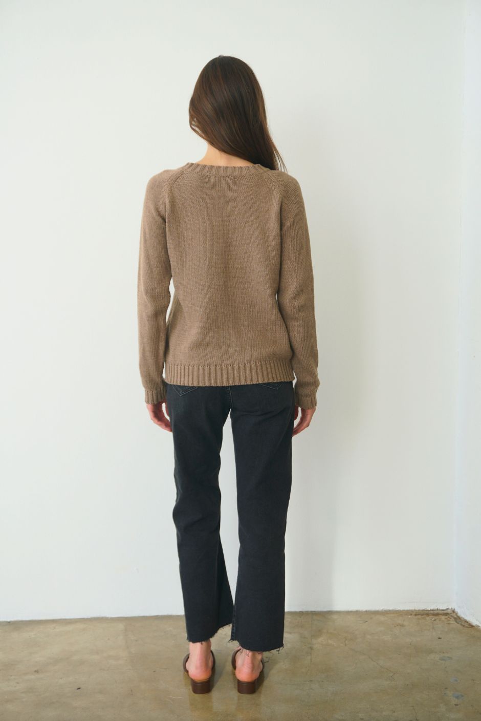 Brown sustainable cotton handknitted Sloane Crewneck by Paneros Clothing. Relaxed-fit hip-length crewneck sweater with long sleeves and ribbing details. Back View.