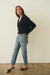 Dark Navy Blue sustainable cropped-length Cotton Diana Cardigan from Paneros Clothing with real coconut shell button-up front, Full sleeves, and feminine handknittting. Side view buttoned.