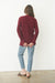 Burgundy Sustainable Cotton Hip-Length Button-up Emily Cardigan by Paneros Clothing. Hand-knitted, slightly oversized cardigan with real coconut shell buttons and ribbed detailing. Back View.