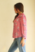 Pink Floral Print Anna Shirt from Paneros Clothing with button-up front and long sleeves. Sustainable rayon dobby shirt blouse in pink floral print with contrast navy piping details. Side View.