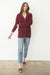 Burgundy Sustainable Cotton Hip-Length Button-up Emily Cardigan by Paneros Clothing. Hand-knitted, slightly oversized cardigan with real coconut shell buttons and ribbed detailing. Front View buttoned.