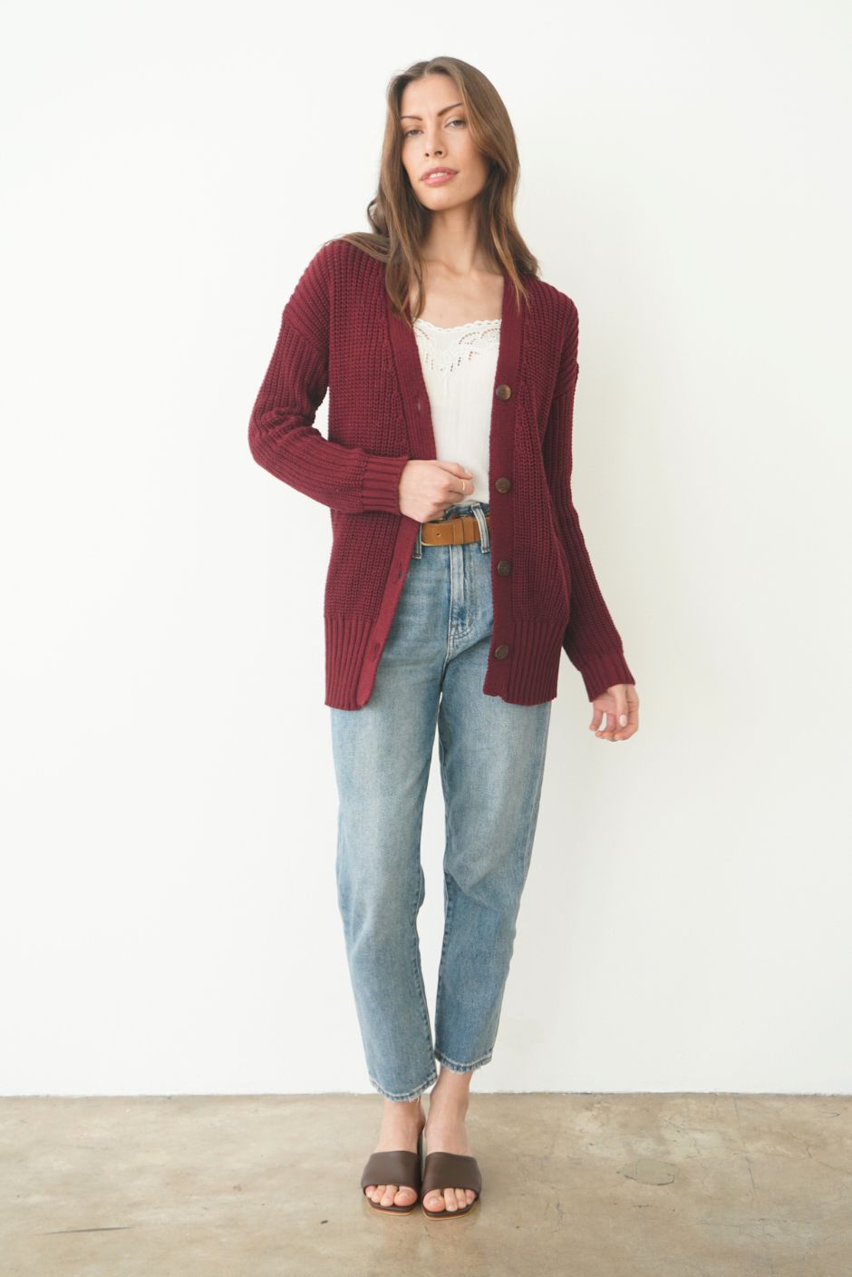 Burgundy Sustainable Cotton Hip-Length Button-up Emily Cardigan by Paneros Clothing. Hand-knitted, slightly oversized cardigan with real coconut shell buttons and ribbed detailing. Front View unbuttoned.