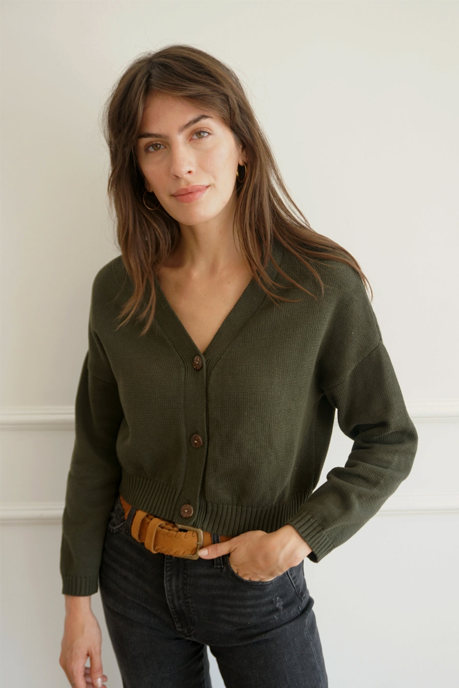 Dark Forest Green sustainable cropped-length Cotton Diana Cardigan from Paneros Clothing with real coconut shell button-up front, Full sleeves, and feminine handknittting. Front View buttoned.