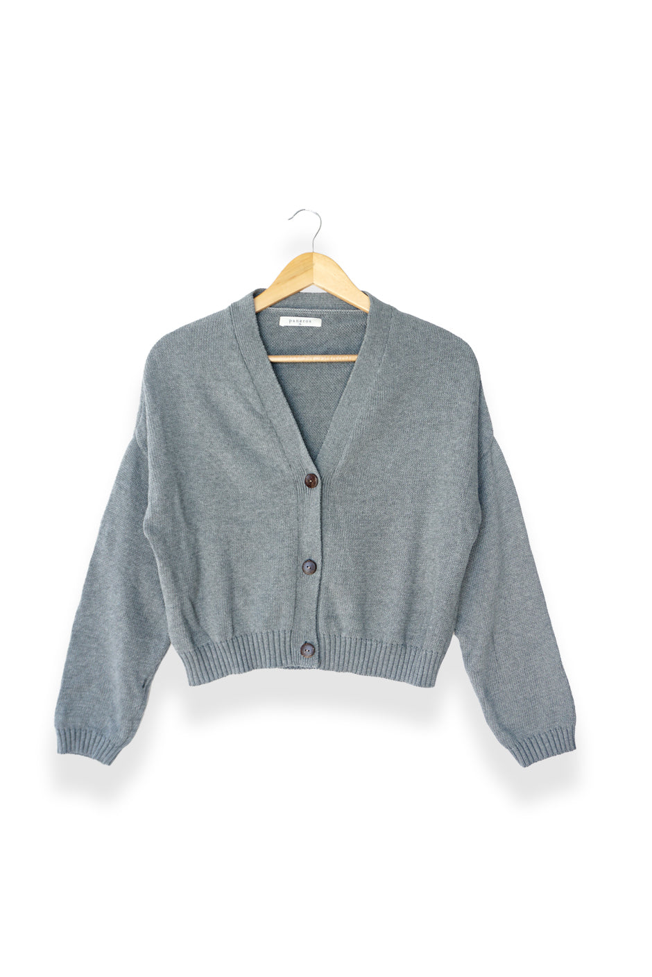 Light Heather Grey sustainable cropped-length Cotton Diana Cardigan from Paneros Clothing with real coconut shell button-up front, Full sleeves, and feminine handknittting. Front View buttoned.