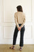 Tan sustainable cropped-length Cotton Diana Cardigan from Paneros Clothing with real coconut shell button-up front, Full sleeves, and feminine handknittting. Back View.