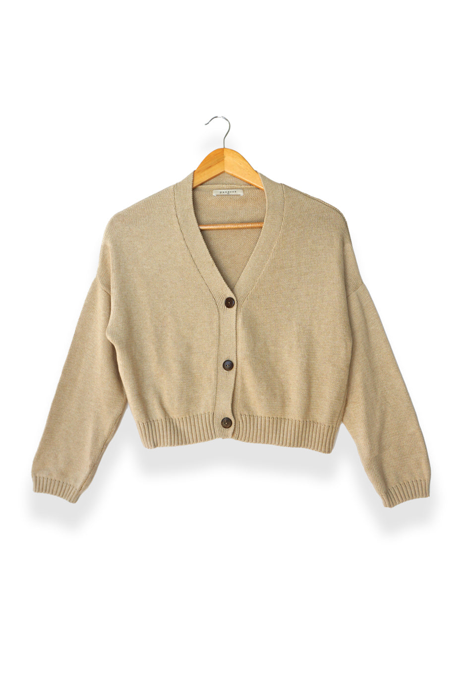 Tan sustainable cropped-length Cotton Diana Cardigan from Paneros Clothing with real coconut shell button-up front, Full sleeves, and feminine handknittting. Front View buttoned.