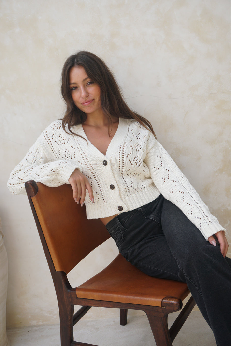 Creamy Off-White Long Sleeve Women&#39;s Pointelle Stitch Button-up Cardigan in Oat Milk from Paneros Clothing with 100% certified sustainable cotton. Front View.