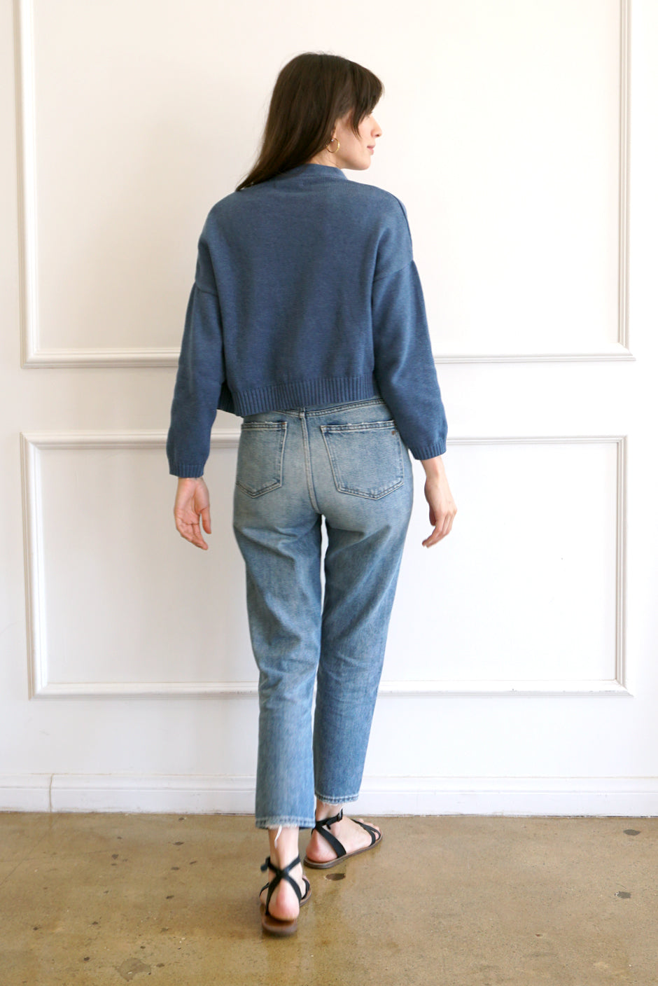 Denim Blue sustainable cropped-length Cotton Diana Cardigan from Paneros Clothing with real coconut shell button-up front, Full sleeves, and feminine handknittting. Back View.