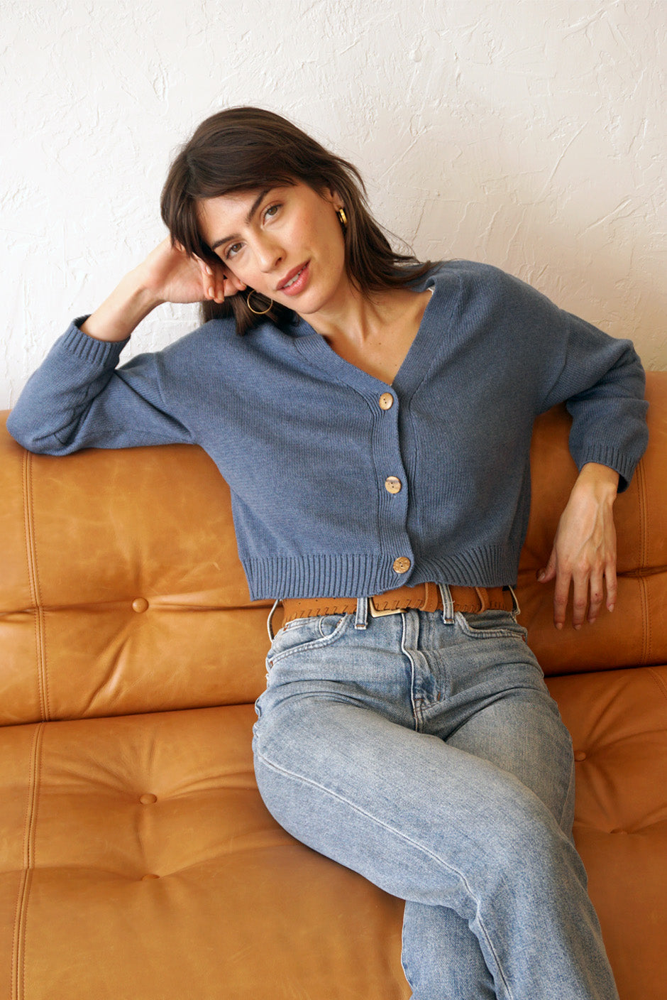 Denim Blue sustainable cropped-length Cotton Diana Cardigan from Paneros Clothing with real coconut shell button-up front, Full sleeves, and feminine handknittting. Front View buttoned.