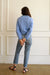 Baby Blue sustainable cropped-length Cotton Diana Cardigan from Paneros Clothing with real coconut shell button-up front, Full sleeves, and feminine handknittting. Back View.