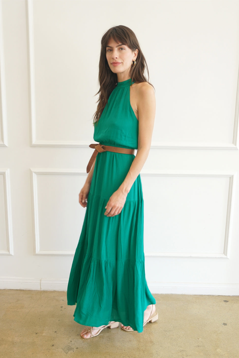 Emerald Green Sustainable Maxi Dress from Paneros Clothing: the Gia. Halter neckline, elastic at the waist, with ruffles.  Side View.