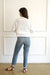 Bright Sugar White sustainable cropped-length Cotton Diana Cardigan from Paneros Clothing with real coconut shell button-up front, Full sleeves, and feminine handknittting. Back View.