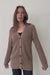 Mocha Brown Sustainable Cotton Hip-Length Button-up Emily Cardigan by Paneros Clothing. Hand-knitted, slightly oversized cardigan with real coconut shell buttons and ribbed detailing. Full Body View in motion, buttoned.