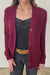 Burgundy Sustainable Cotton Hip-Length Button-up Emily Cardigan by Paneros Clothing. Hand-knitted, slightly oversized cardigan with real coconut shell buttons and ribbed detailing. Detailed Full Body View in motion, unbuttoned.