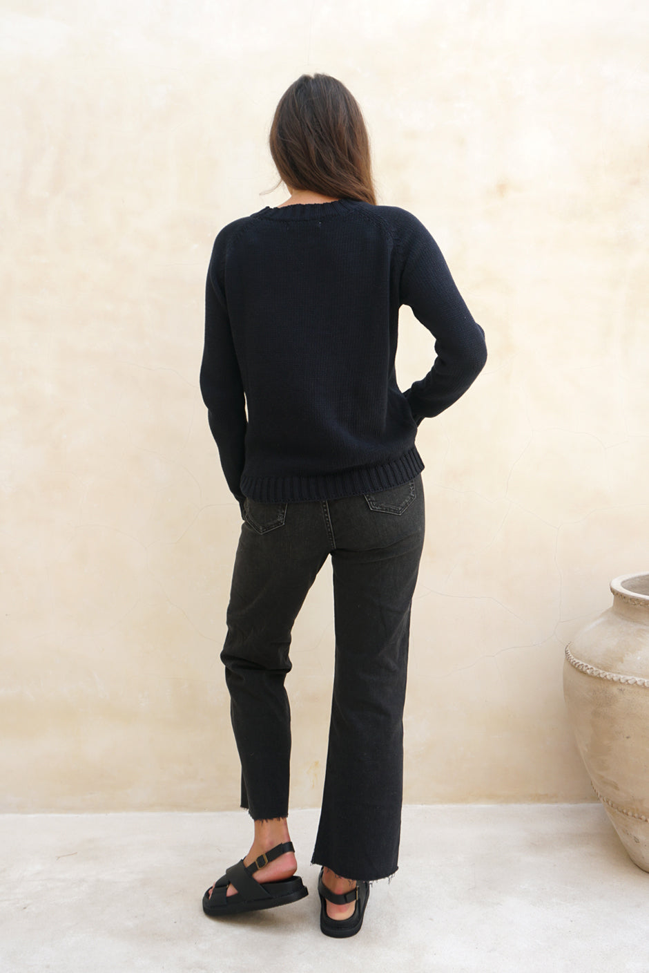 Navy Blue sustainable cotton handknitted Sloane Crewneck by Paneros Clothing. Relaxed-fit hip-length crewneck sweater with long sleeves and ribbing details. Back View.