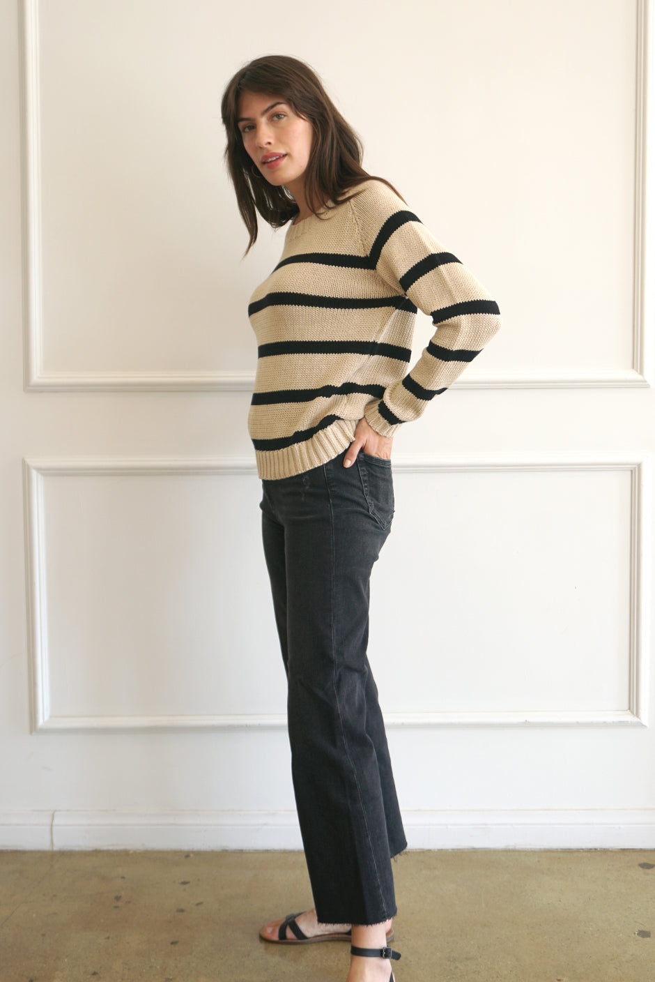 Tan and Black Striped sustainable cotton handknitted Sloane Crewneck by Paneros Clothing. Relaxed-fit hip-length crewneck sweater with long sleeves and ribbing details. Side View.