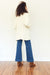 Ali handknitted cardigan for women by Paneros Clothing. 100% cotton in white.  Back View.