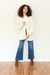 Ali handknitted cardigan for women by Paneros Clothing. 100% cotton in white.  Front View.