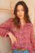 Red Boho Print Spring/Summer 2023 Anna Shirt from Paneros Clothing with button-up front and long sleeves. Front View tucked into denim.