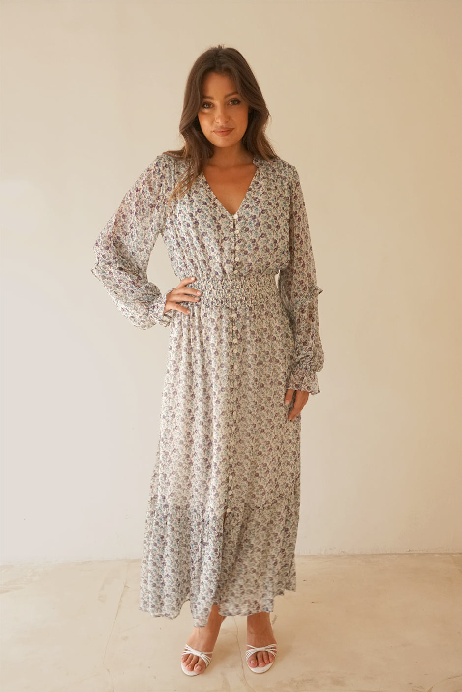 White/Blue/Purple Floral Print Long Sleeve Women's Aria Ankle-lenght Maxi Dress from Paneros Clothing with 100% certified sustainable fabric, ruffles, button-up front, and smocking. Front View close up.