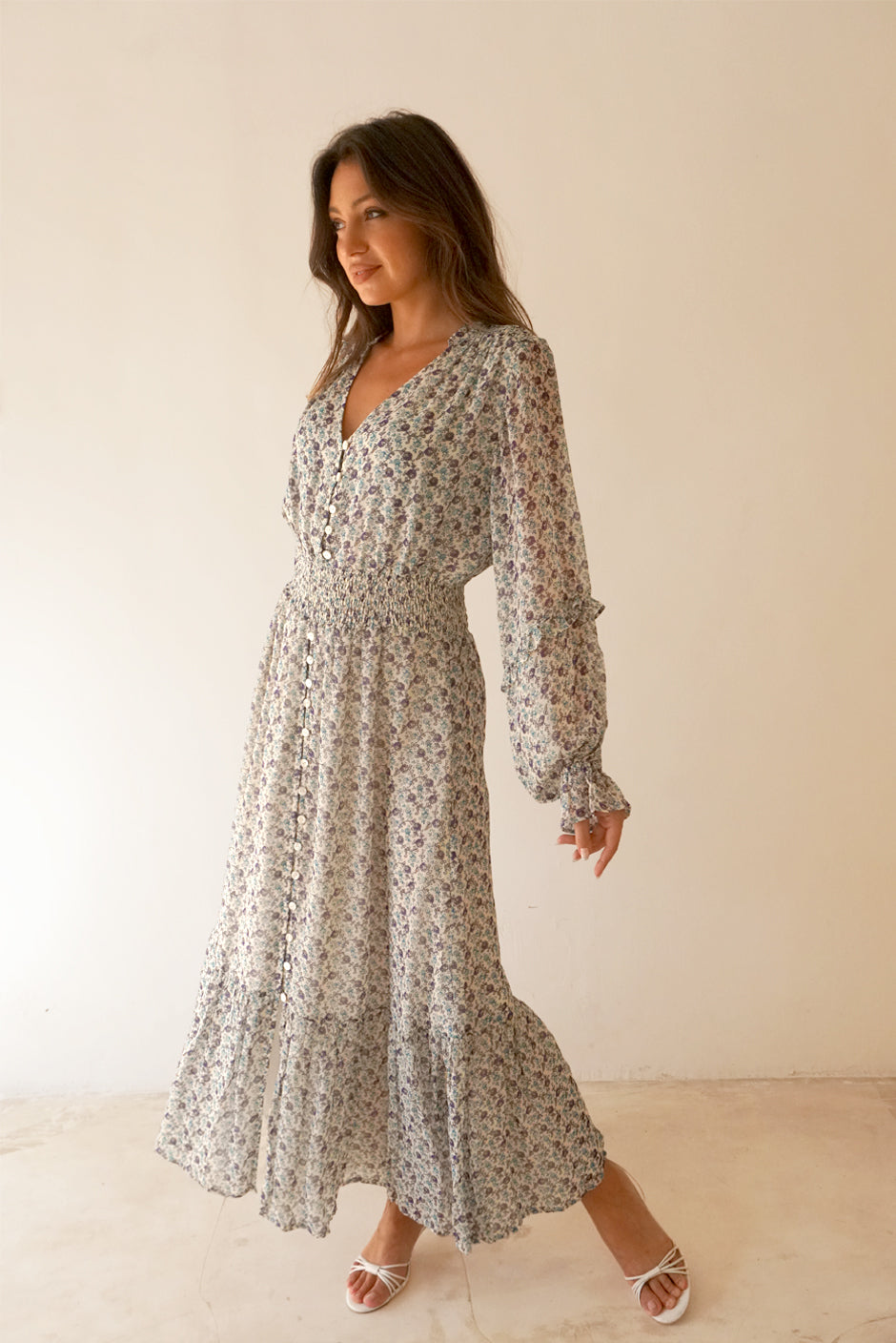 White/Blue/Purple Floral Print Long Sleeve Women's Aria Ankle-lenght Maxi Dress from Paneros Clothing with 100% certified sustainable fabric, ruffles, button-up front, and smocking. Side View.