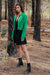 Diana cropped Cardigan in Emerald Green color for women by Paneros Clothing. Handknitted from sustainable deadstock cotton yarn, with full sleeves and vintage crystal buttons. Side view styled with Dress.