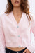 Light Pink sustainable cropped-length Cotton Diana Cardigan from Paneros Clothing with real coconut shell button-up front, Full sleeves, and feminine handknittting. Front Detailed View buttoned.