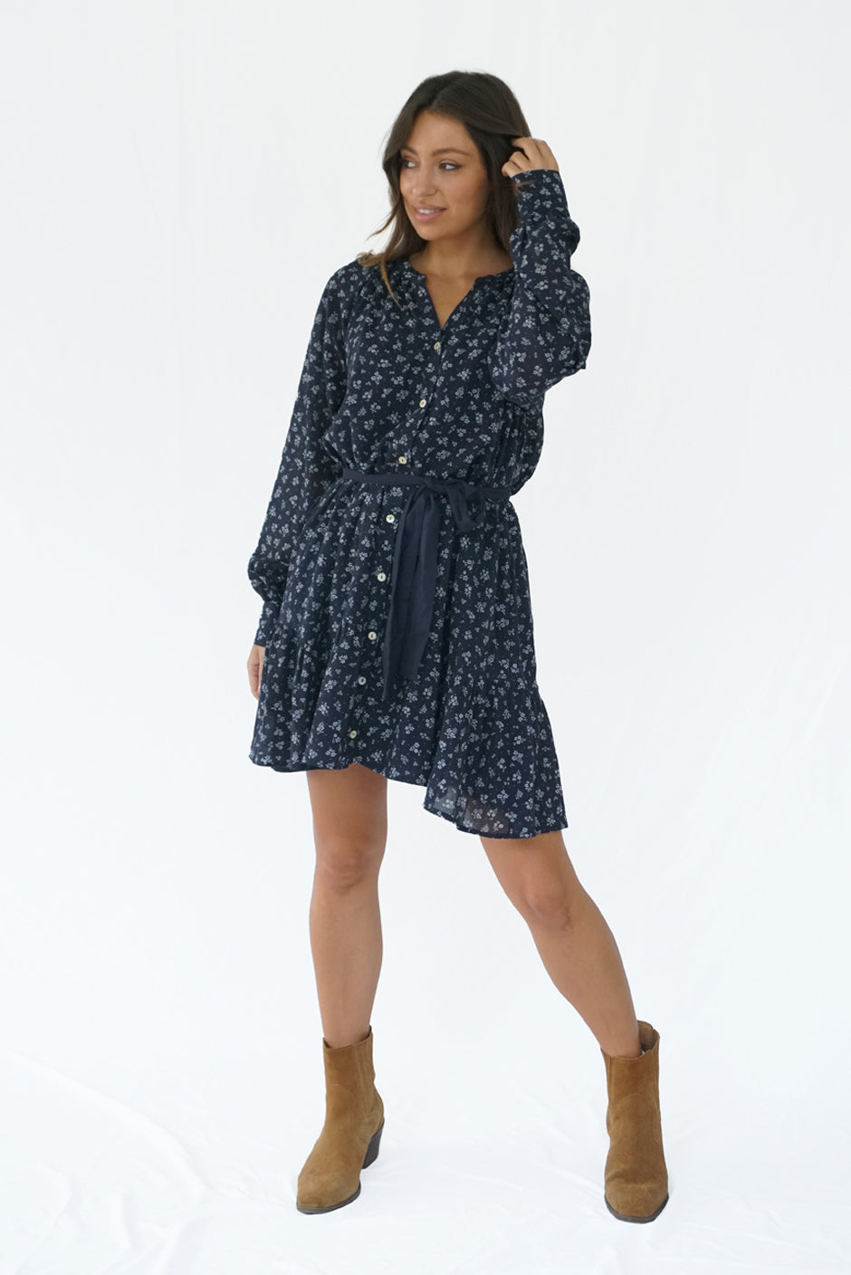 Floral Print Long Sleeve Women's Ella Above-the-Knee Mini Dress from Paneros Clothing with 100% certified sustainable fabric and smocking. Side View with cinch waist & button front.