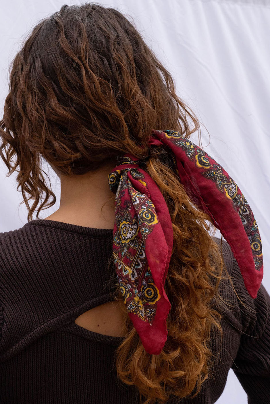 Vintage Freya bandana in Berry Red handcrafted in India Featuring a multicolor paisley print for women by Panero Clothing. Hair Tie view.