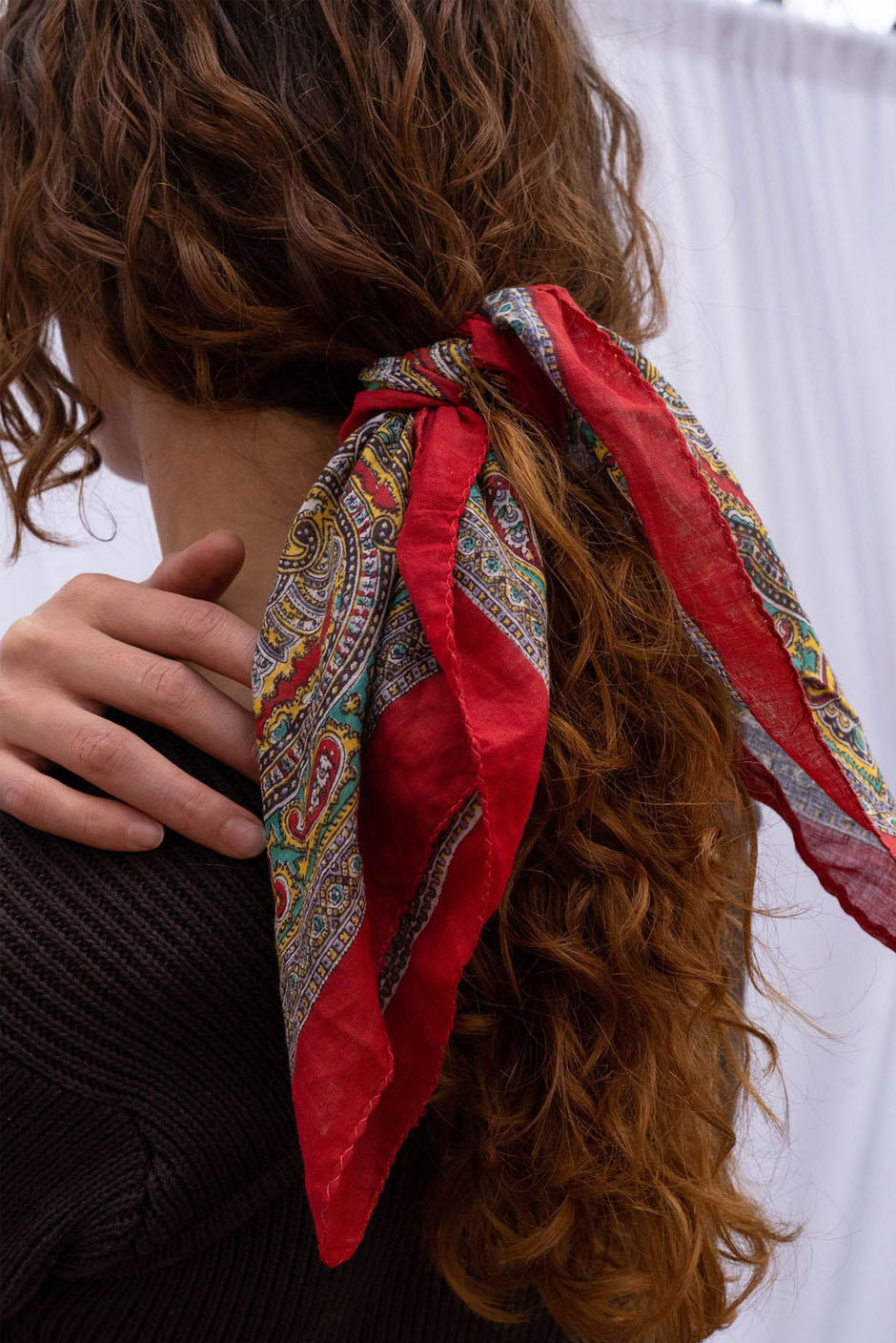 Vintage Freya bandana in Chilli Red handcrafted in India Featuring a multicolor paisley print for women by Panero Clothing. Hair tie view.