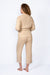 Haley Cardigan in Sand Color for women by Paneros Clothing. Made from sustainable cotton, with waist sash. Back view.