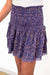 Purple Bohemian Floral Paisley Print Spring/Summer 2022 Lennon Smocked Mini Skirt from Paneros Clothing styled with white tank top. Front Side Detail View.