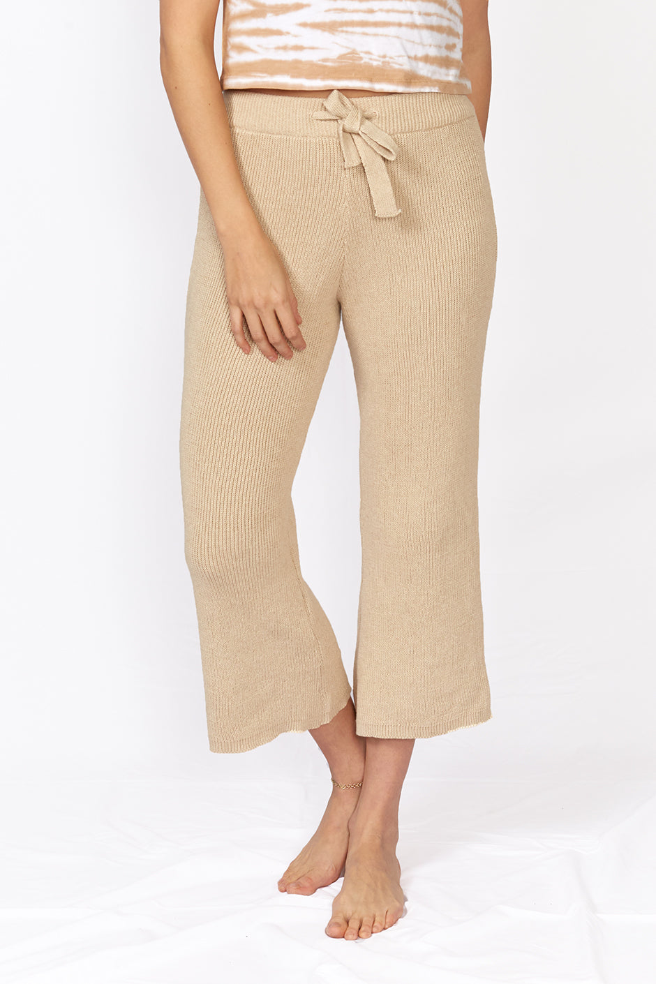 Mirage Pant in Sand color for women by Paneros Clothing. Handmade from sustainable cotton, high waisted and tied with a flare. Front View.